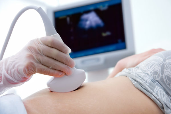 woman getting ultrasound diagnostic from doctor